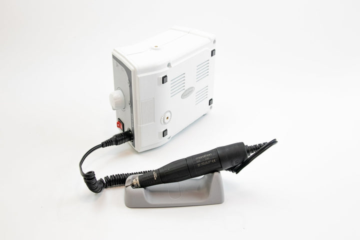 Nail drill and power supply on a white background